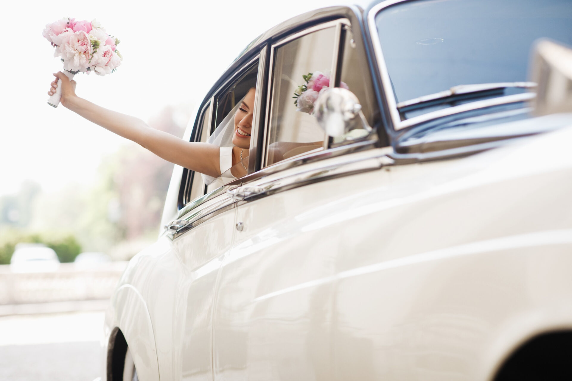 beautiful-bride-sits-with-wedding-bouquet-retro-car-has-fun
